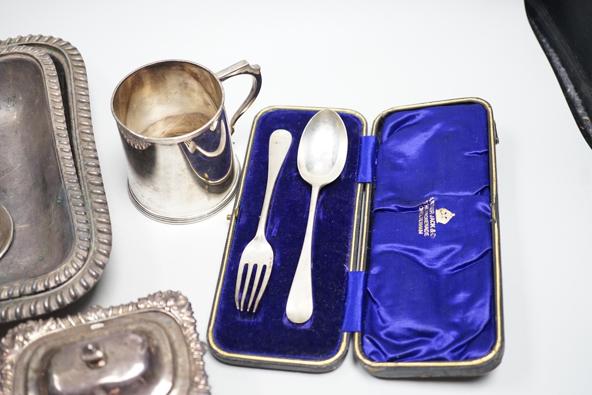 A small collection of English silver to include a pair of Victorian cauldron salts, two small beakers, a cream jug with presentation script, a George IV silver mustard pot with hinged cover, London, 1823 and a boxed chri